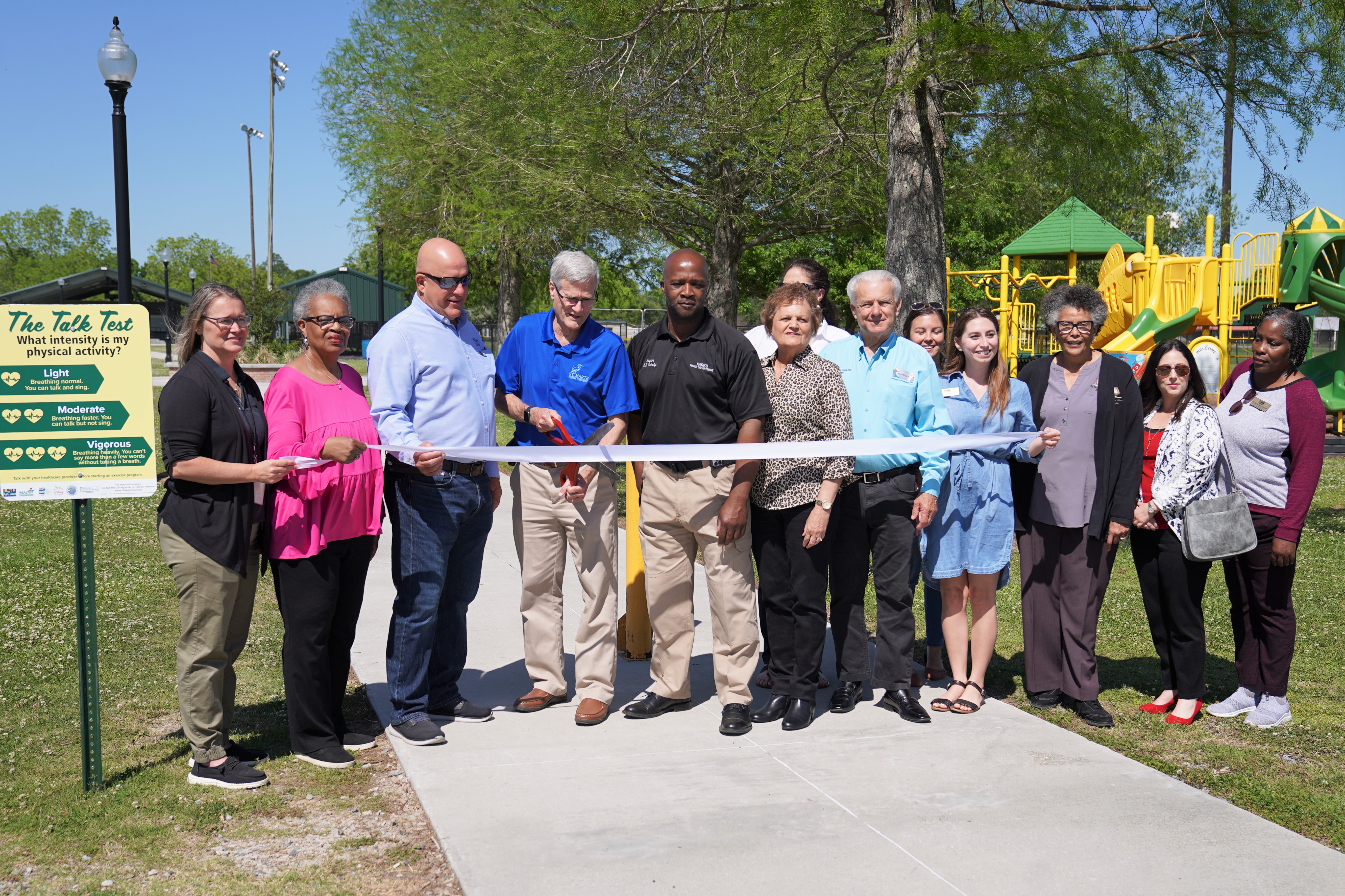 Coalition members standing together for ribbon cutting at park